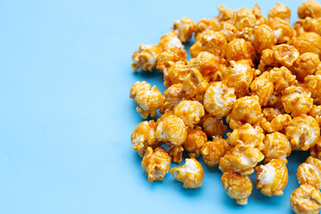 Honey caramel popcorn on blue background.