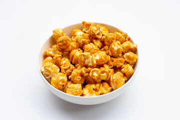 Honey caramel popcorn on white background.