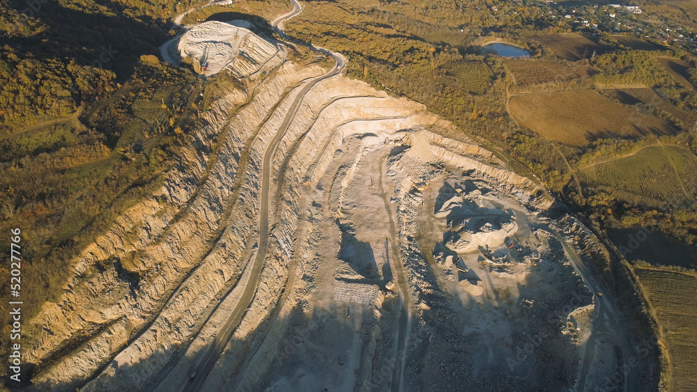 Poster Panoramic view of quarry. Shot. Top view of picturesque quarry located on coastal mountain near village in forest. Concept of mining