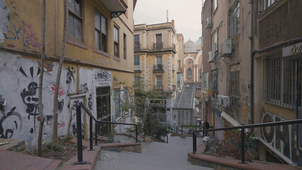 Old empty streets of Turkish city. Action. Narrow city streets with graffiti of old residential...