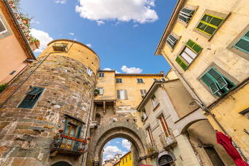 An arched city gate inside the historic center of the Tuscan medieval city of Lucca, Italy