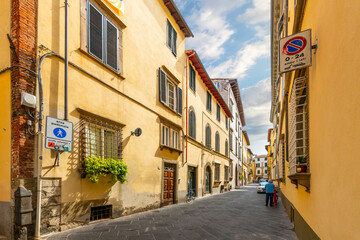 A typical street through the medieval historic center of the Tuscan city of Lucca, Italy.