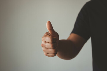 Man shows thumb up sign gesture. Businessman showing OK approve or like signal with thumb raise up. Successful concept.