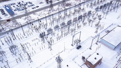 Top view of electric city substation. Action. Electrical substation with transformers distributing...