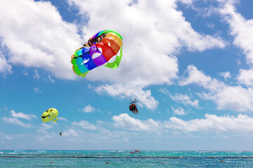 Parasailing above the ocean at tropical islands. Copy space, holiday fun activities caribbean see. Bavaro Punta cana.