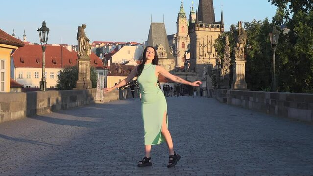 Young woman in Prague dance and Jumping for Create Viral Reel dance Jump. Video cut transaction changing  location in jump.