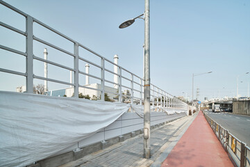 Empty Riverside Bike Path with Railings, Urban Outdoor Background