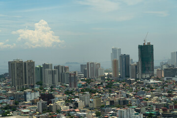 Obraz premium Skyscrapers and business centers in a big city Manila. Urban aerial landscape. Modern metropolis in Asia, top view.
