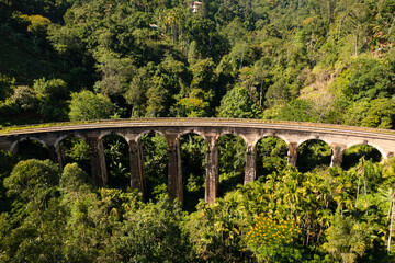 Fototapeta na wymiar Nine Arches Bridge In Highlands Near Ella, Sri Lanka. Jungle And Tea Plantation All Around.