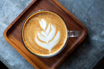 White cup of tasty cappuccino with art latte.