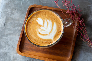 White cup of tasty cappuccino with art latte.