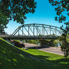Finlay Bridge over South Saskatchewan River and the green hill of Veteran's Memorial Park in Medicine Hat city in Alberta, Canada