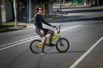 Naklejka premium Healthy young Latin man riding around the city on his bike.