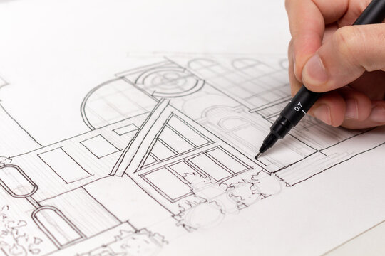 Making an architectural sketch with a pen.