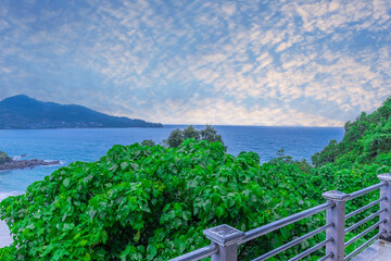 Colourful Skies Sunset over Head Laem Sing Beach in Phuket Thailand. This Lovely island waters are turquoise blue waters, lush green mountains colourful skies and beautiful views of Pa Tong Patong