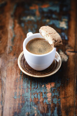Cup of coffee and Cantuccini (Italian cookie) on dark wooden background. Copy space.