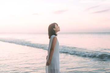 Portrait of asian woman at the beach rest in the sea waves aesthetic vibes