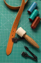 tanner's work table with leather working equipment