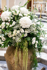 Delicate flowers in the vase at the wedding ceremony