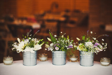 Bouquets of flowers in vase on the wedding table