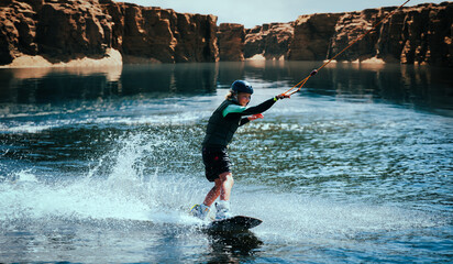 Wakeboarder making tricks on the river. Wakeboarding. Water sports.