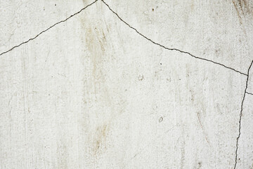 Old white concrete wall with cracks for the background.