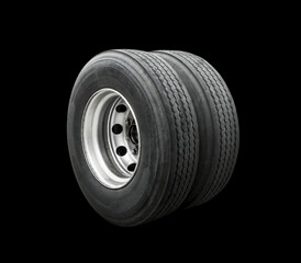 Fototapeta premium Big Semi Truck Wheels Tires Isolated on Black. Rubber, Truck Tyres. Freight Trucks Transport Logistics. Auto Service Shop. 