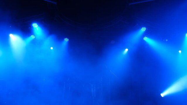 Stage lighting beams spotlight and smoke of events show or concerts	
