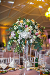 Bouquet of flowers in vase on the wedding table