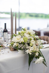 Bouquet of flowers in vase on the wedding table