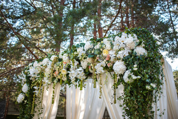 Flowers on the arch for the wedding ceremony
