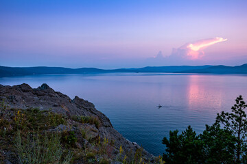 Scenic lake and rocky shore after sunset