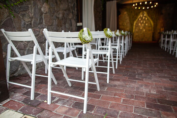 Wooden chairs for an outdoor wedding ceremony
