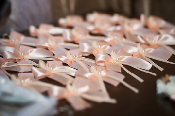 Close-up of decorations for wedding guests lying on the table in pink tones