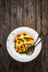 Pasta with asparagus, parmesan and tomatoes on wooden table
