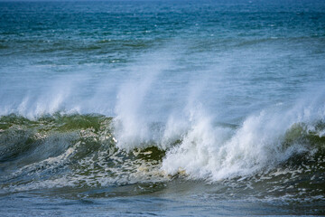 Beautiful early morning ocean waves with spray been bown by strong winds. Hermanus. Whale Coast. Overberg. Western Cape. South Africa