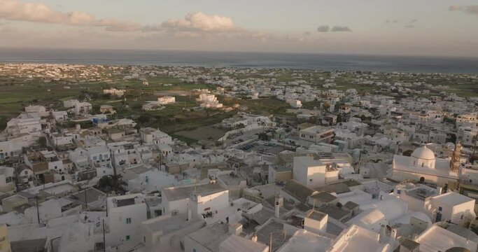 Aerial footage of white buildings in old town of Santorini island, Greece