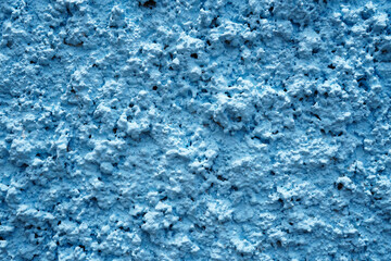 Fototapeta na wymiar Blue or pastel plaster wall surface, abstract painted background, close-up, outdoor, blur (spot focus)