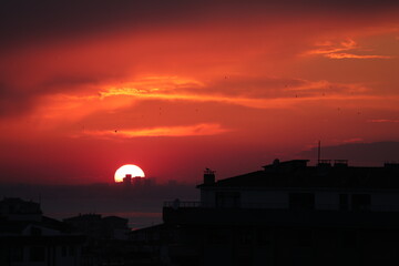 sunset over the city, red sky and clouds