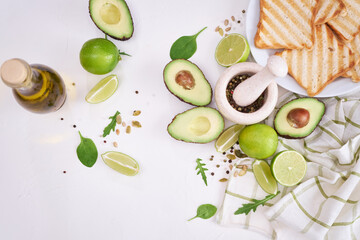 Making avocado toast - fresh ripe halved avocado and ingredients