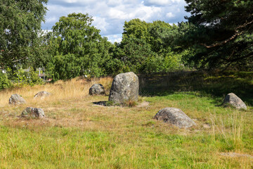 Iron age stone circle on grassy hill in western Sweden, Europe.