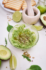 Toasts preparation - Mashed avocados in a glass bowl