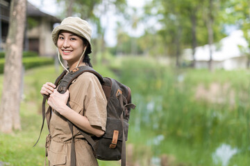 Asian girl backpack in nature , Relax time on holiday concept travel,Photographer Travel Sightseeing Wander Hobby Recreation Concept.