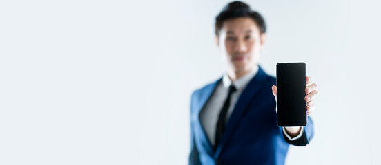 hand smartphone close up asian businessman wear formal blue suit hand show blank screen smartphone...