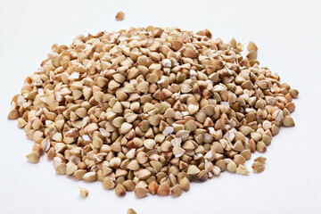 Pile of buckwheat seeds isolated on white background, closeup.
