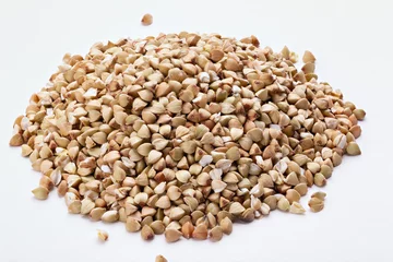Poster Pile of buckwheat seeds isolated on white background, closeup. © alexshyripa