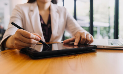 Fototapeta premium Businessman and team analyzing financial statement Finance task. with smart phone and laptop and tablet. Wealth management concept