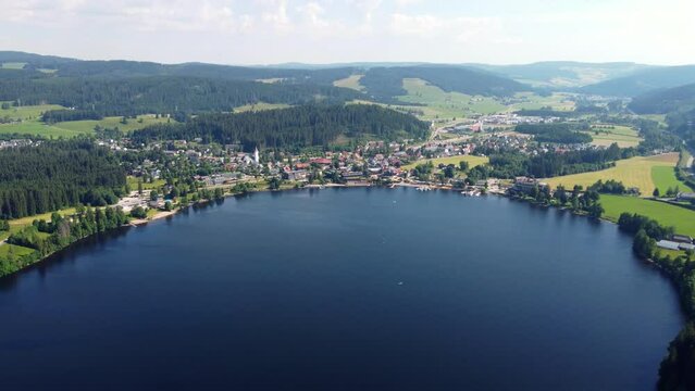 Aerial drone footage of flight over the scenic Lake Titisee in the Black Forest in Southern Germany at sunset