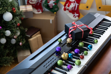 Christmas ball on piano keys. Carol music concept