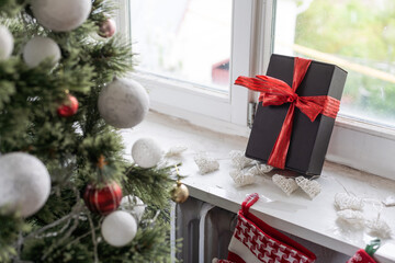 Beautiful holdiay decorated room with Christmas tree with presents under it.